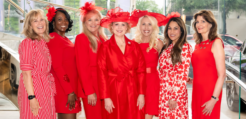 Group photo of Circle of Red members dressed in red dresses and hats. Group photo of Circle of Red members dressed in red dresses and hats.